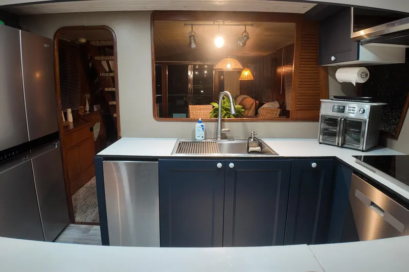 Slide: The Image of Modern kitchen interior on 1987 Viking Gulfstar yacht, featuring stainless steel appliances and sleek design. - 18