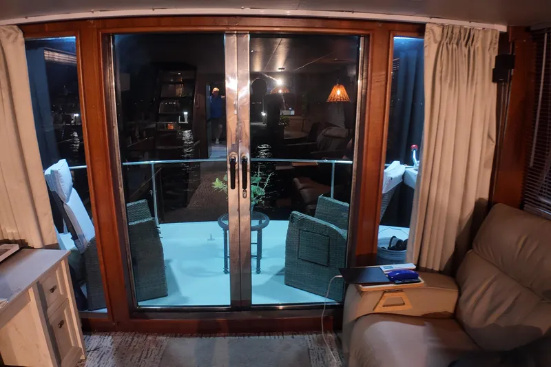 Slide: The Image of Interior view of 1987 Viking Gulfstar yacht with sliding glass doors and cozy seating. - 20