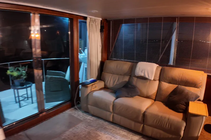 Slide: The Image of Cozy interior of 1987 Viking Gulfstar yacht with beige sofa and sliding glass doors. - 22