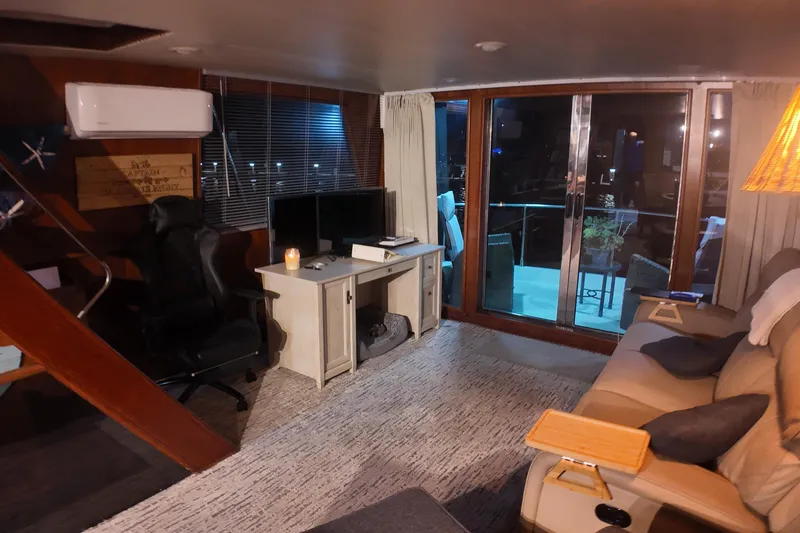 Slide: The Image of Cozy interior of 1987 Viking Gulfstar yacht with desk, chair, and sliding glass doors. - 23
