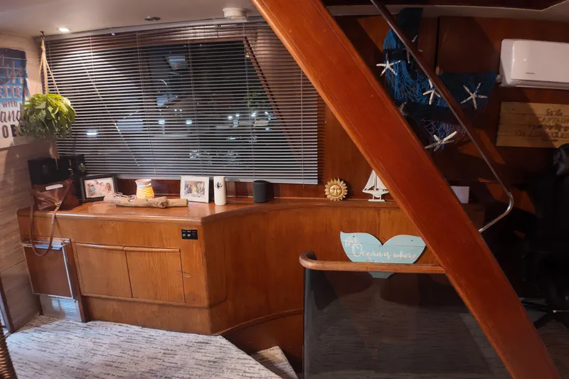 Slide: The Image of Interior of 1987 Viking Gulfstar yacht with wooden decor and nautical-themed decorations. - 24