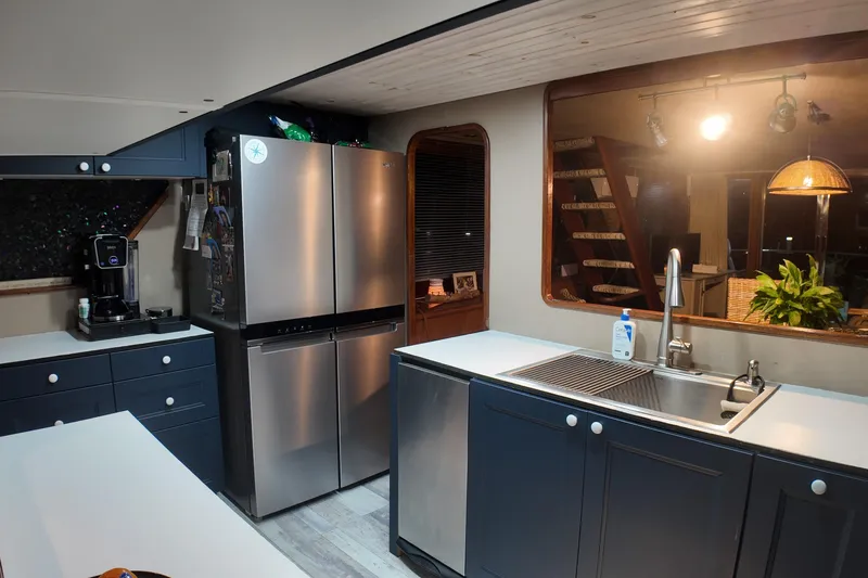 Slide: The Image of Modern kitchen interior on a 1987 Viking Gulfstar boat with stainless steel appliances. - 27
