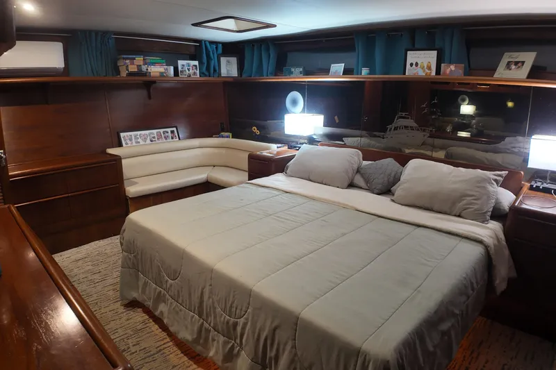 Slide: The Image of Luxurious bedroom interior of 1987 Viking Gulfstar yacht with elegant wood finishes and cozy bedding. - 33