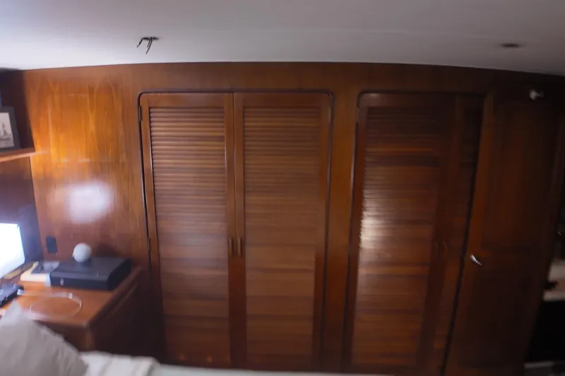 Slide: The Image of Wood-paneled interior of 1987 Viking Gulfstar yacht with louvered closet doors. - 34
