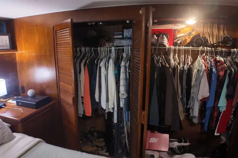Slide: The Image of Closet interior on 1987 Viking Gulfstar yacht with clothes and shoes neatly organized. - 35