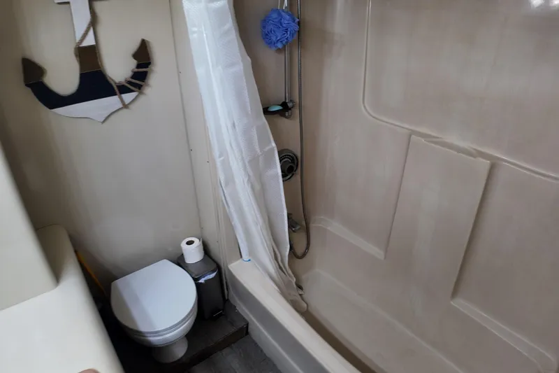 Slide: The Image of Bathroom in 1987 Viking Gulfstar boat with shower, toilet, and anchor decor. - 40