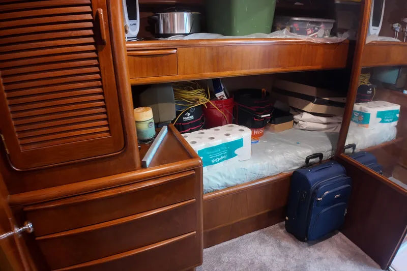 Slide: The Image of Interior of 1987 Viking Gulfstar with wooden cabinets and storage items. - 45