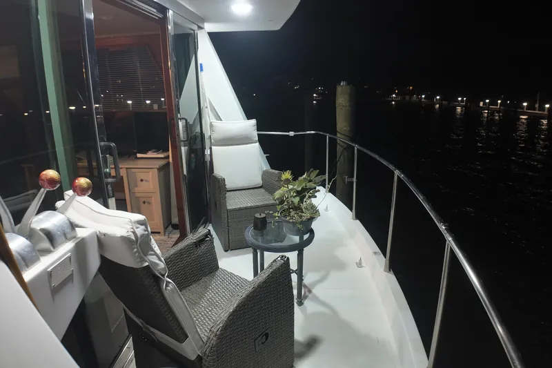 Slide: The Image of 1987 Viking Gulfstar yacht deck at night with chairs and table. - 49