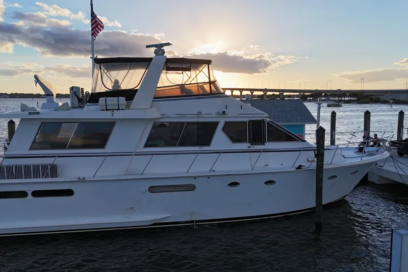 Slide: The Image of 1987 Viking Gulfstar yacht docked at sunset with American flag. - 5
