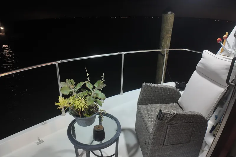 Slide: The Image of Cozy deck of 1987 Viking Gulfstar yacht with chair and potted plant at night. - 50