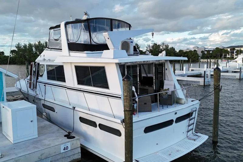 Slide: The Image of 1987 Viking Gulfstar yacht docked at marina, featuring spacious deck and modern design. - 8