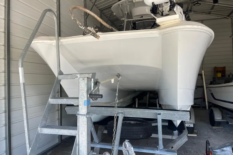 Slide: The Image of 2020 Twin Vee 230 JP CC boat on trailer in storage facility. - 2
