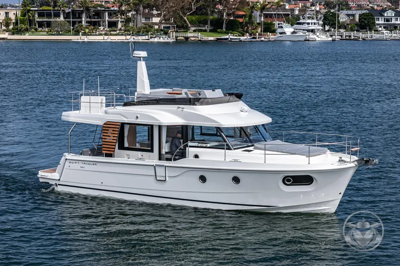 Slide: The Image of 2026 Beneteau Swift Trawler 41 Fly cruising on a serene waterfront. - 13