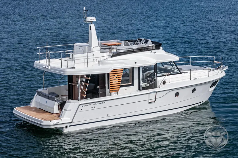 Slide: The Image of 2026 Beneteau Swift Trawler 41 Fly cruising on open water, showcasing sleek design and spacious deck. - 16