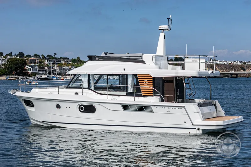 Slide: The Image of 2026 Beneteau Swift Trawler 41 Fly cruising on a scenic waterfront. - 21
