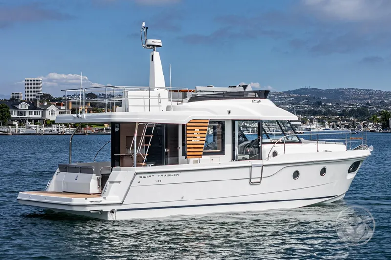 Slide: The Image of 2026 Beneteau Swift Trawler 41 Fly cruising on a scenic waterfront. - 22