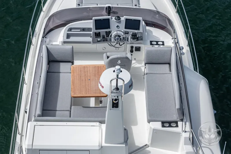 Slide: The Image of 2026 Beneteau Swift Trawler 41 Flybridge with helm, seating, and table, viewed from above. - 28