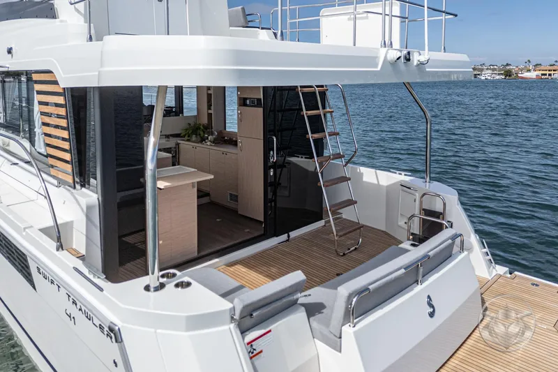 Slide: The Image of 2026 Beneteau Swift Trawler 41 Fly, spacious deck and modern interior on the water. - 36
