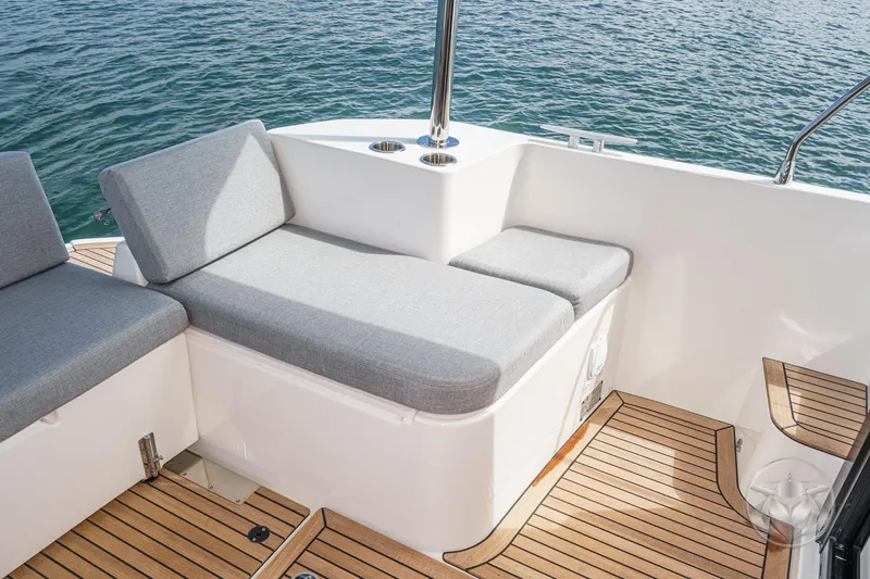 Slide: The Image of 2026 Beneteau Swift Trawler 41 Fly deck with cushioned seating and teak flooring. - 37