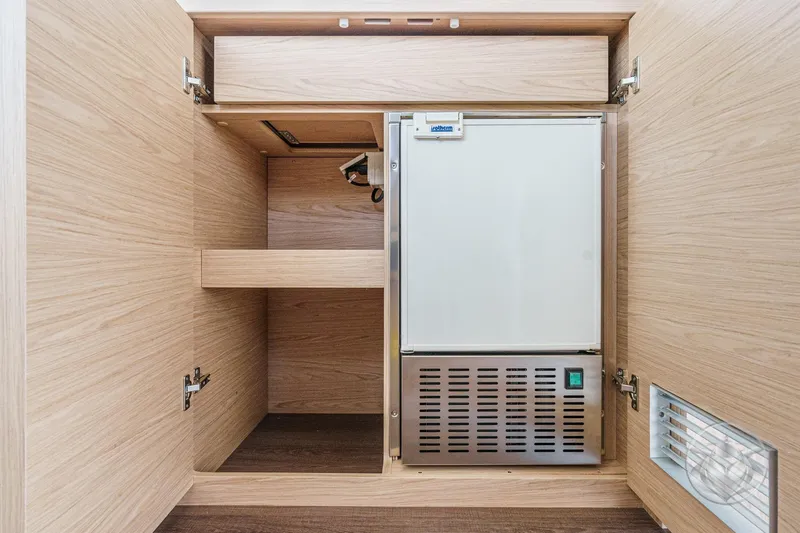 Slide: The Image of 2026 Beneteau Swift Trawler 41 Fly interior cabinet with built-in refrigerator. - 50