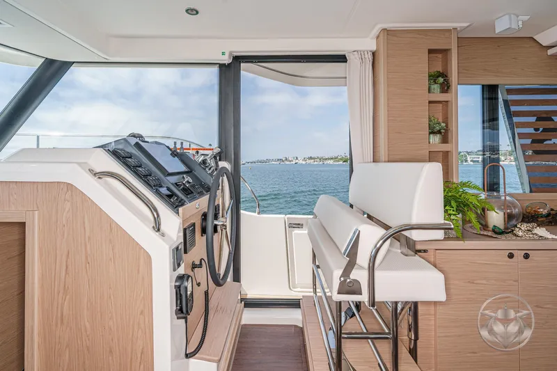 Slide: The Image of Interior of 2026 Beneteau Swift Trawler 41 Fly, featuring helm and seating area. - 57