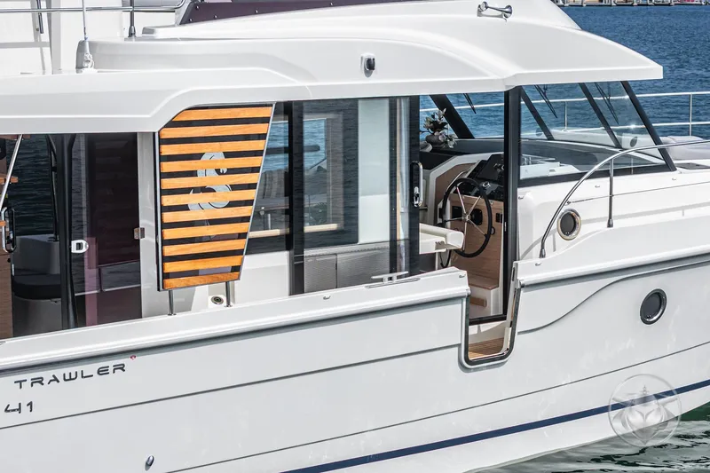 Slide: The Image of 2026 Beneteau Swift Trawler 41 Fly, sleek design, modern interior, docked on water. - 58