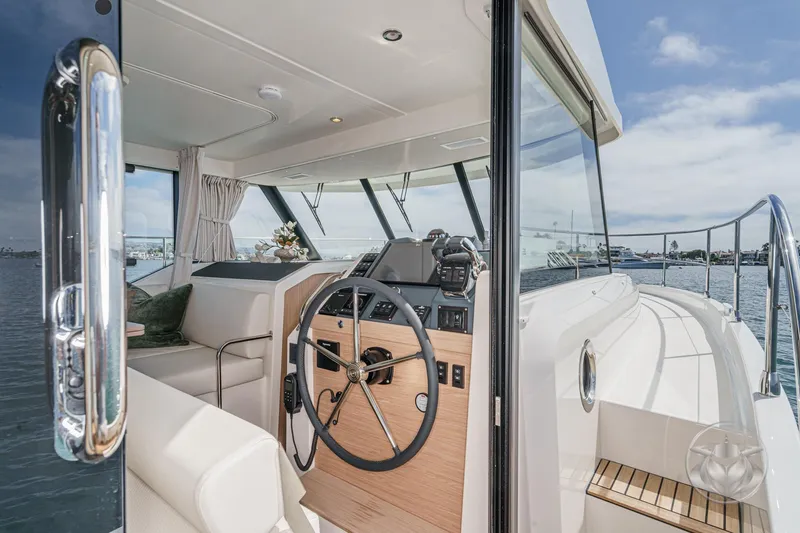 Slide: The Image of 2026 Beneteau Swift Trawler 41 Fly helm with modern controls and panoramic view. - 60
