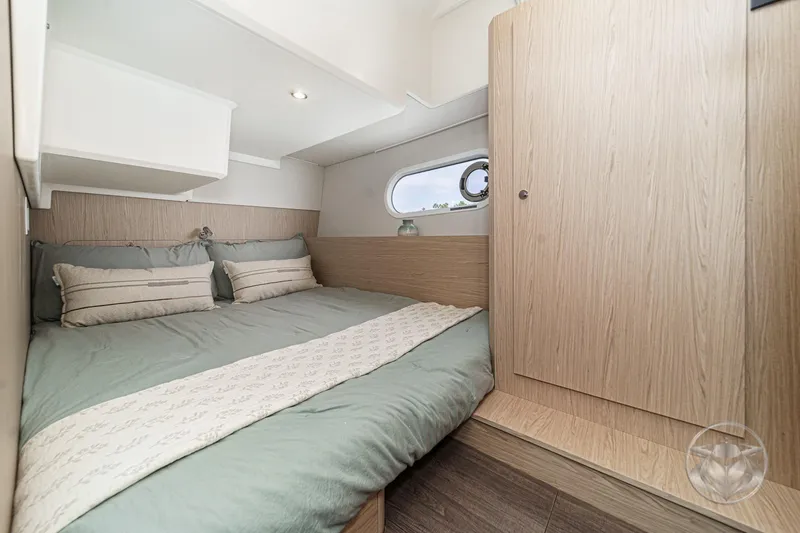Slide: The Image of Cozy bedroom in 2026 Beneteau Swift Trawler 41 Fly, featuring modern wood finishes. - 65