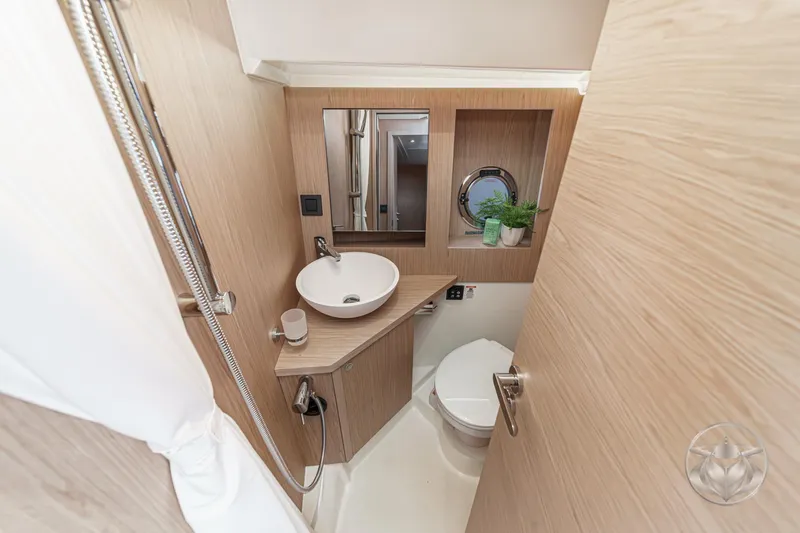 Slide: The Image of 2026 Beneteau Swift Trawler 41 Fly bathroom with modern fixtures and wooden accents. - 70