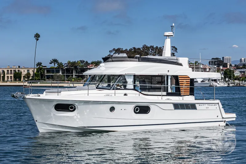 Slide: The Image of 2026 Beneteau Swift Trawler 41 Fly cruising on a calm waterway. - 8