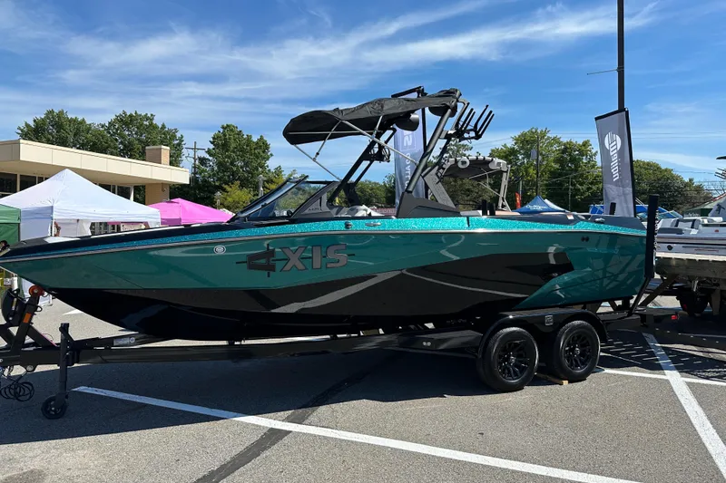 The Image of 2025 Axis A225 boat on trailer at outdoor event, showcasing sleek design and vibrant color. - 0