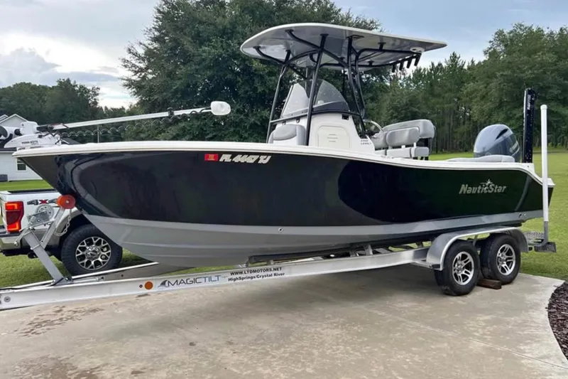 The Image of 2022 NauticStar 2302 Legacy boat on trailer, parked outdoors. - 1