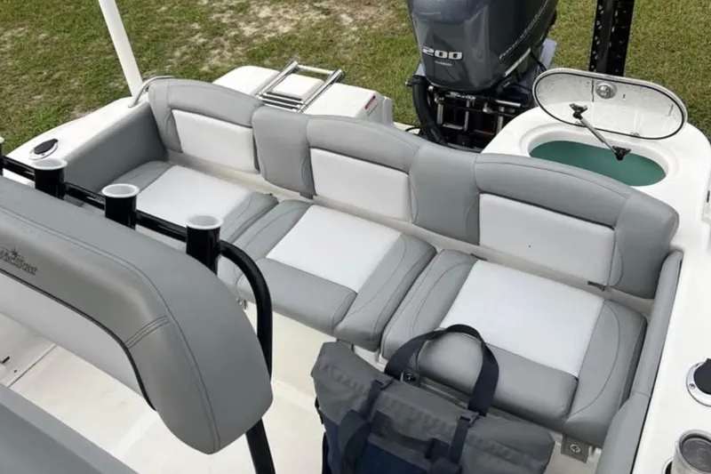 Slide: The Image of 2022 NauticStar 2302 Legacy boat interior with seating and motor. - 3