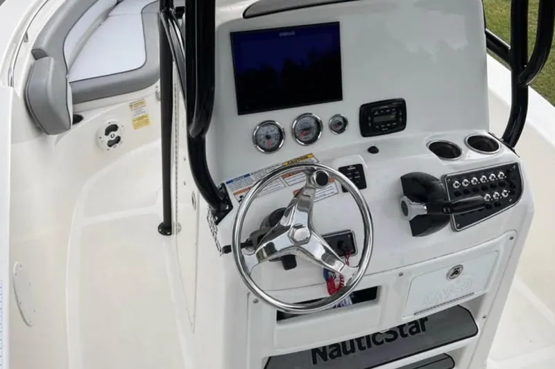 Slide: The Image of 2022 NauticStar 2302 Legacy boat console with steering wheel and control panel. - 4