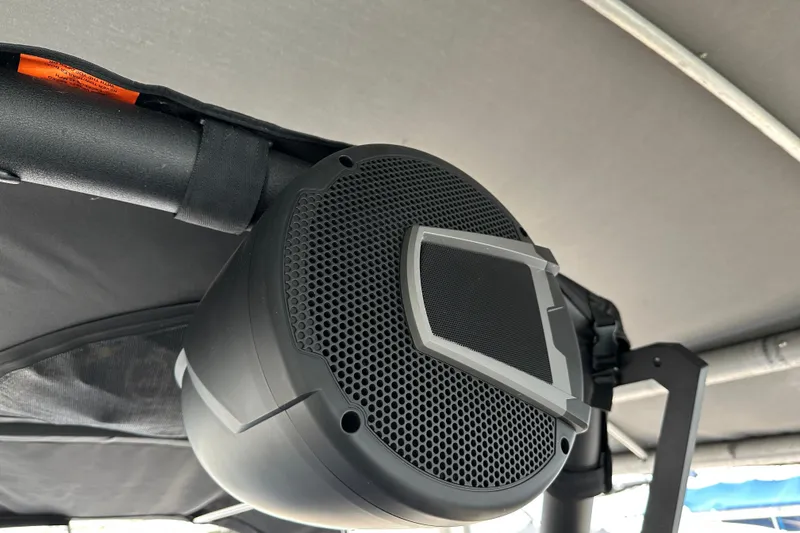 Slide: The Image of Black speaker mounted on Axis A245 boat, 2025 model, under a canopy. - 11