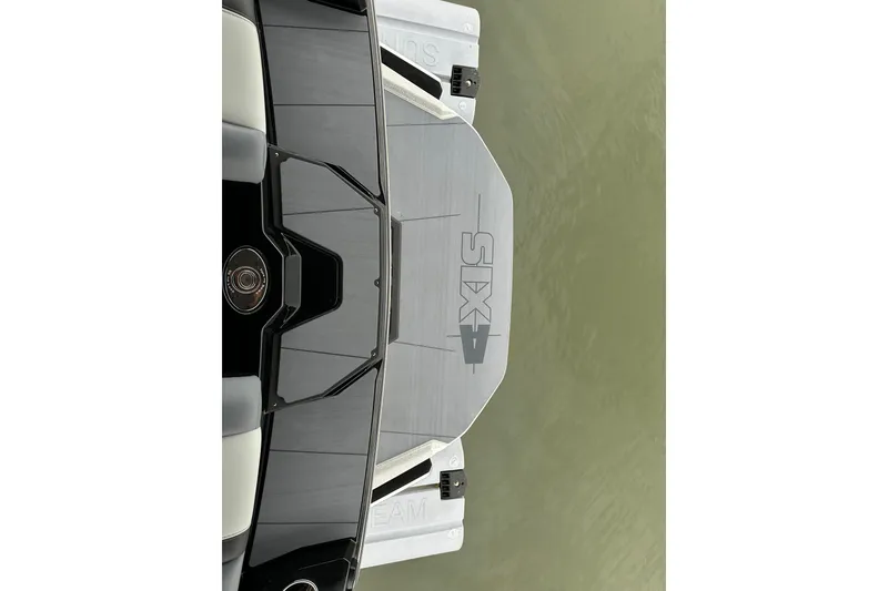 Slide: The Image of 2025 Axis A245 boat platform with "SIX" logo on calm water. - 14