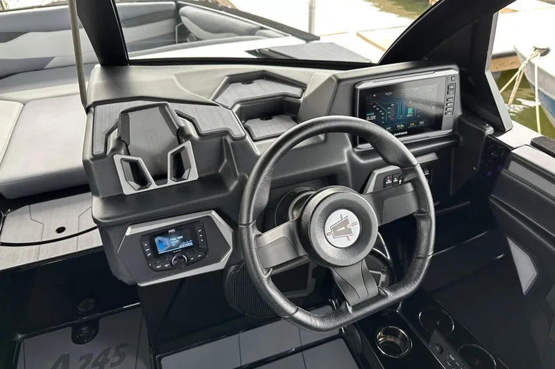 Slide: The Image of 2025 Axis A245 boat dashboard with steering wheel, digital display, and control panel. - 6