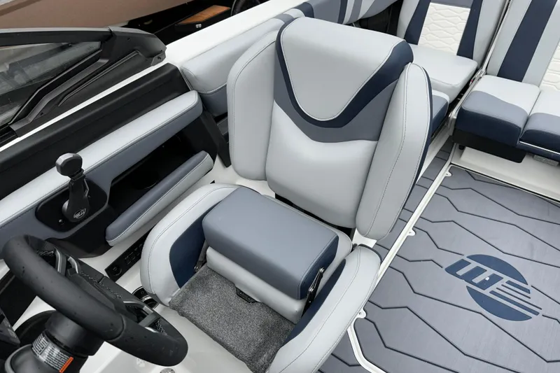 Slide: The Image of 2025 Malibu Wakesetter 22 MXZ interior with sleek, modern seating and steering wheel design. - 10