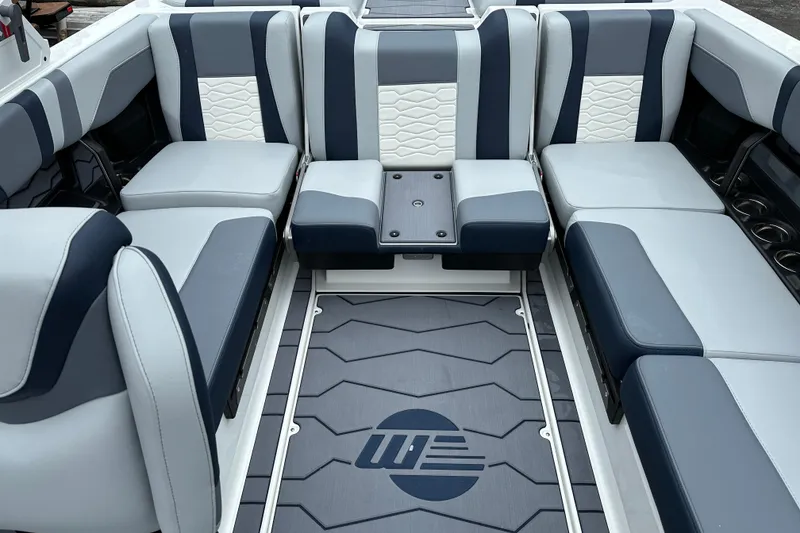Slide: The Image of 2025 Malibu Wakesetter 22 MXZ interior with stylish blue and white seating. - 11