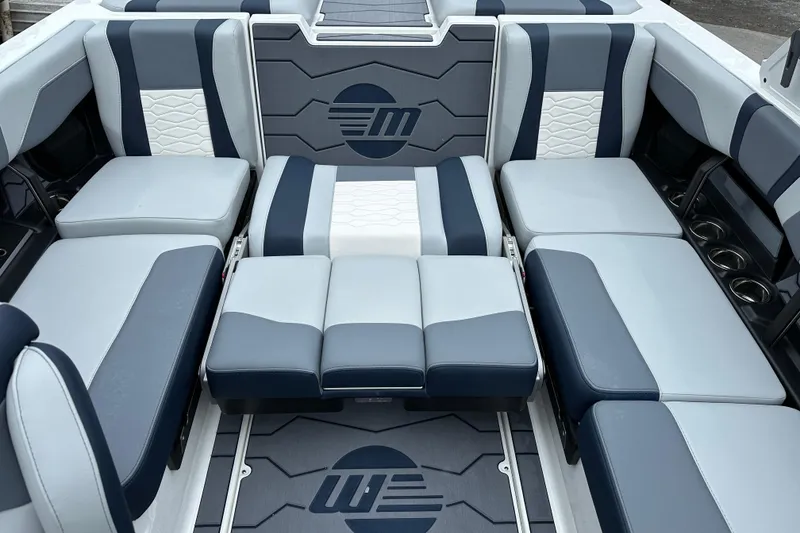 Slide: The Image of 2025 Malibu Wakesetter 22 MXZ interior with stylish blue and white seating. - 12