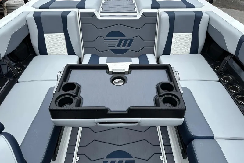 Slide: The Image of 2025 Malibu Wakesetter 22 MXZ interior with stylish seating and cup holders. - 14