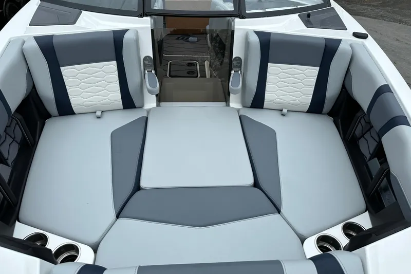 Slide: The Image of 2025 Malibu Wakesetter 22 MXZ interior with gray and white seating, cup holders, and modern design. - 16