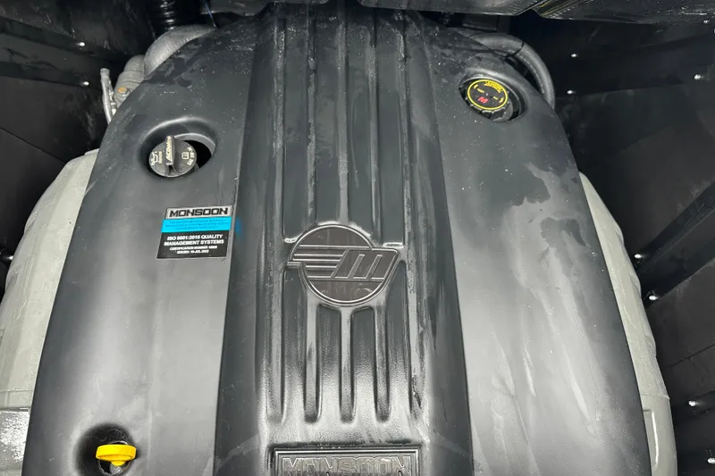 Slide: The Image of Engine cover of 2025 Malibu Wakesetter 22 MXZ with Monsoon branding. - 17