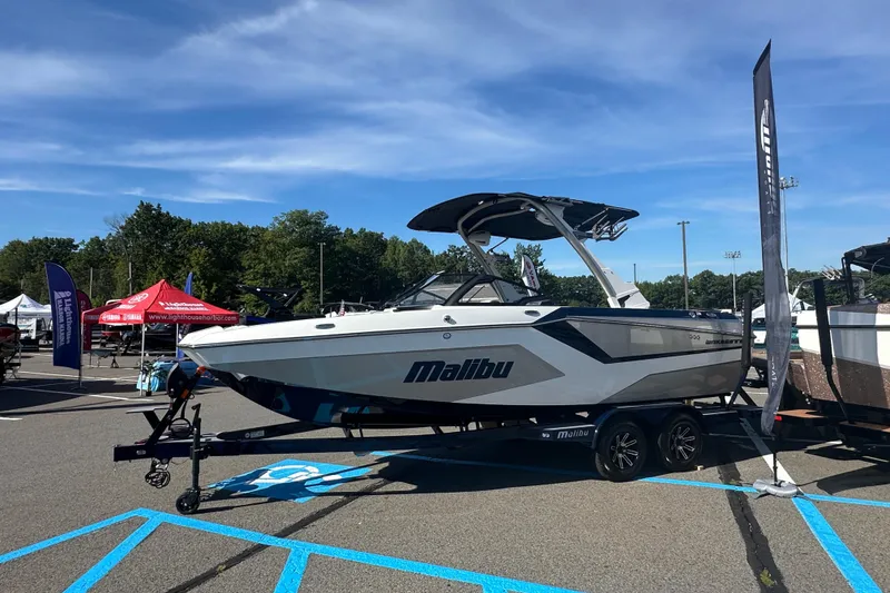 Slide: The Image of 2025 Malibu Wakesetter 22 MXZ boat displayed outdoors on a trailer. - 2