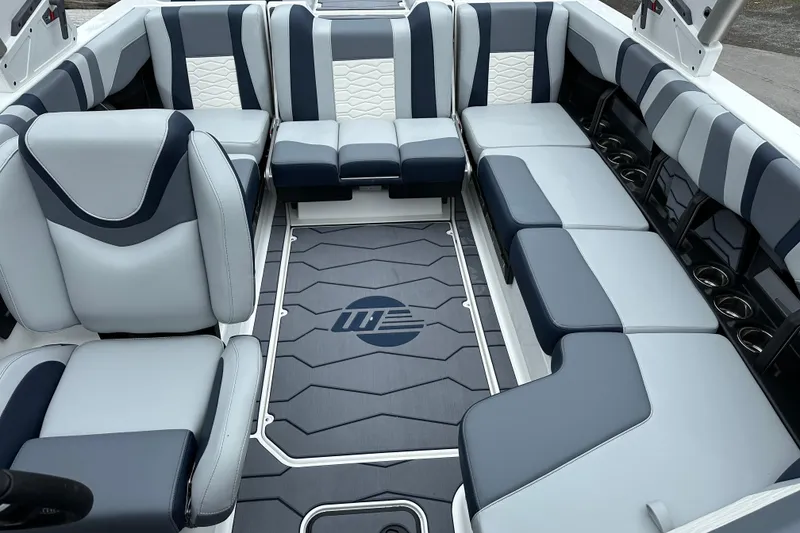 Slide: The Image of 2025 Malibu Wakesetter 22 MXZ interior with stylish gray and blue seating. - 8