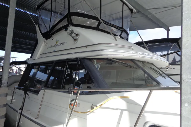 Slide: The Image of 1992 Bayliner 3288 Motoryacht docked in a covered marina. - 10