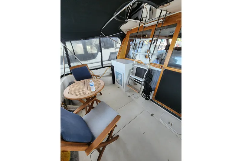 Slide: The Image of 1992 Bayliner 3288 Motoryacht interior with seating, table, and nautical equipment. - 14