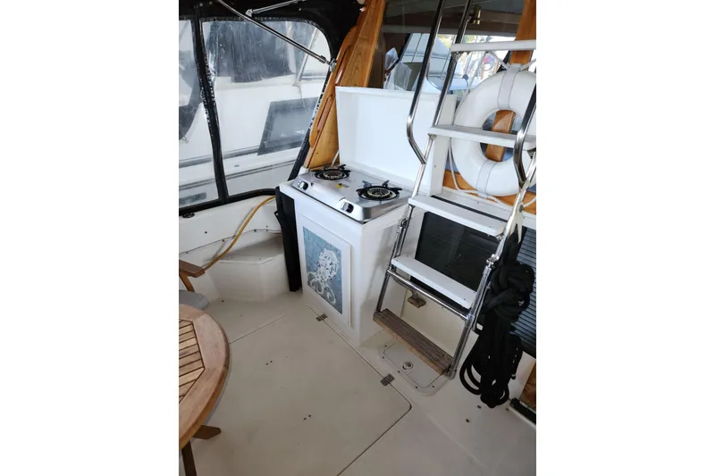 Slide: The Image of 1992 Bayliner 3288 Motoryacht interior with stove, ladder, and life preserver. - 16