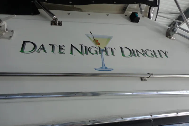 Slide: The Image of 1992 Bayliner 3288 Motoryacht with "Date Night Dinghy" name and martini glass graphic. - 17