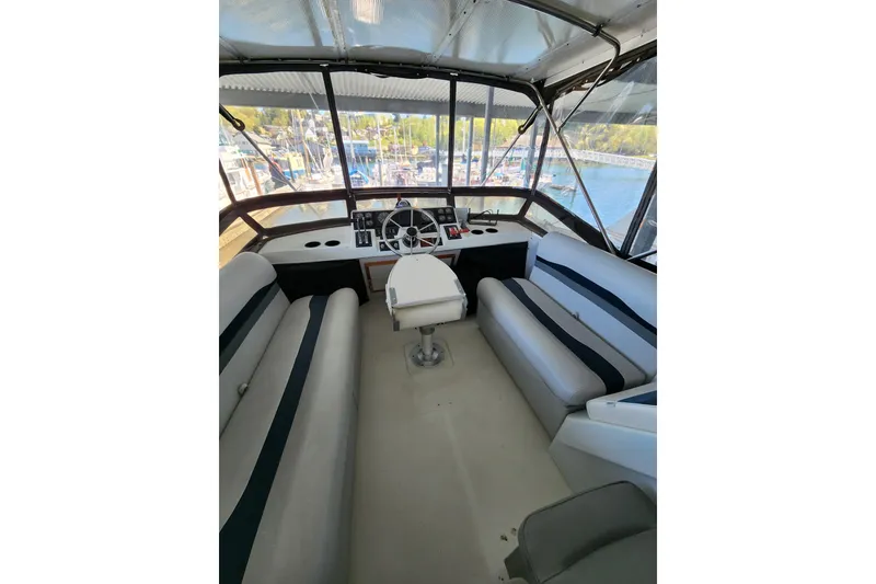 Slide: The Image of 1992 Bayliner 3288 Motoryacht helm with seating, overlooking marina view. - 19